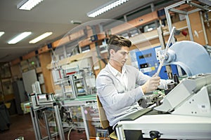 Young man in electronics workshop