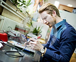 Young man in electronics workshop