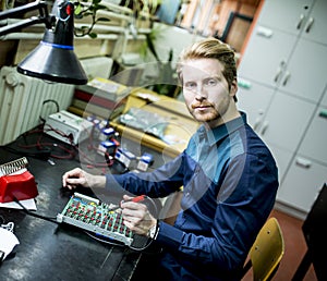 Young man in electronics workshop