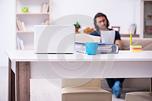 Young man employee working from house