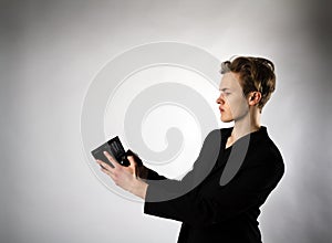 Young man and empty wallet