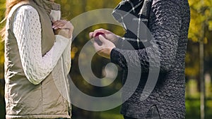 Young man with engagement ring making proposal to his beloved girlfriend, love