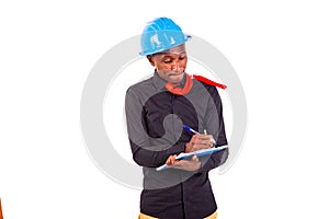 Young man engineer taking notes in clipboard