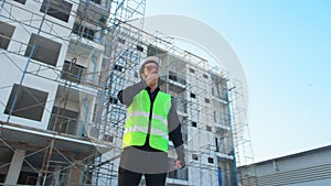 Young man engineer using radio command with worker and survey in construction site.