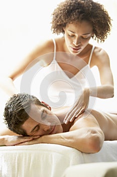 Young Man Enjoying Massage At Spa