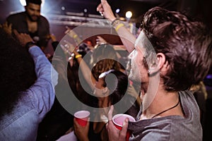 Young man enjoying music concert