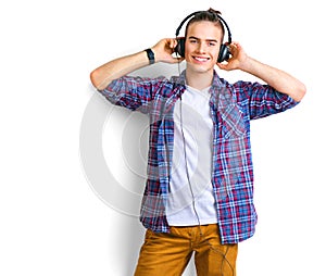 Young man enjoying music in headphones over white