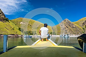 Young man enjoying the tranquil view of Padar Island during summer vacation photo