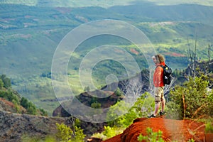 Young man enjoying view into Waimea Canyon