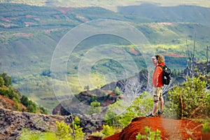 Young man enjoying a view into Waimea Canyon