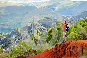 Young man enjoying a view into Waimea Canyon