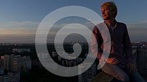 Young man enjoys his life on a high construction site in Kiev.