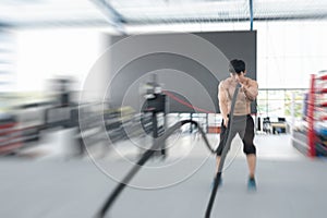 Young man execute exercise in fitness center. male athlete train