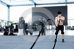 Young man execute exercise in fitness center. male athlete train