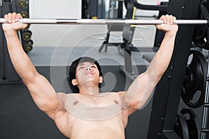 Young man execute exercise with weightlifting machine in fitness