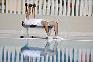 Young man exercise at poolside