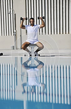 Young man exercise at poolside