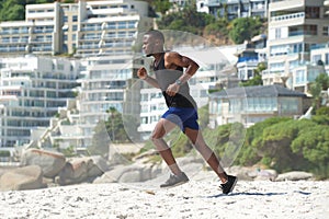 Young man exercise running on the beach