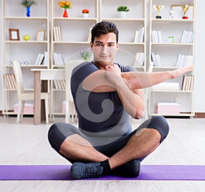 Young man exercising at home in sports and healthy lifestyle con