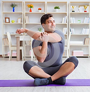 Young man exercising at home in sports and healthy lifestyle con