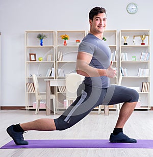 Young man exercising at home in sports and healthy lifestyle con