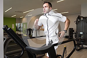 Young Man Exercising On A Treadmill