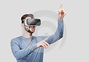 Young man experiencing virtual reality eyeglasses headset. Handsome men using  glasses. Future, gadgets, technology concept.