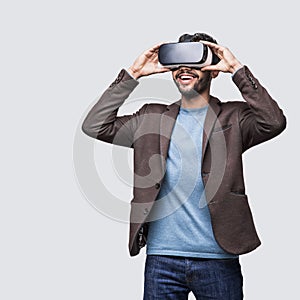Young man experiencing virtual reality eyeglasses headset. Handsome men using vr glasses.