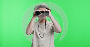 Young man explorer in hat looking through binoculars