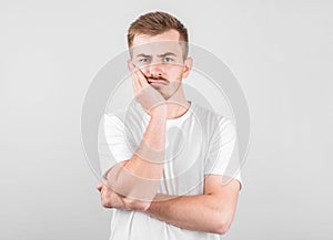 Young man with an expression of discontent on his face