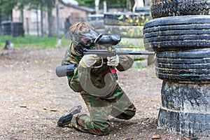 Young man in extreme process of paintball game