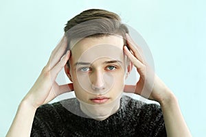 Young man face with hand and headache