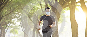 Young man in face mask and running in the park