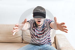 Young man is fascinated from virtual reality headset