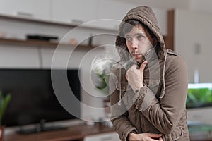 Young man feel cold at home photo