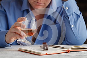 Young man feeling alone and drinking too much alcohol in his own