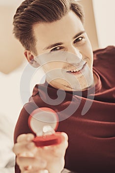 Young man feeling happy while getting ready for engagement with his sweetheart