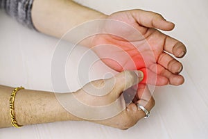 A young man feeling pain in his fingers