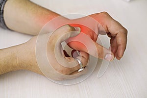 A young man feeling pain in his hand