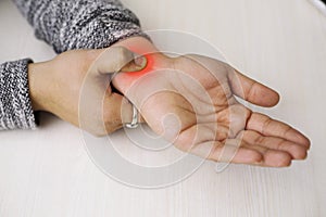 A young man feeling pain in his wrist