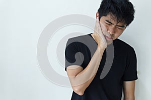 Young man feeling pain, holding his cheek with hand, suffering from bad toothache. Tooth ache concept