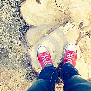 Young man feet in red sneakers