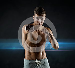 Young man in fighting or boxing position