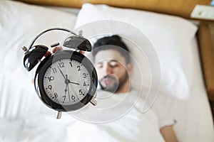Young man finding it difficult to wake up in the morning