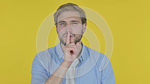 Young Man with Finger on Lips, Silence Yellow Screen