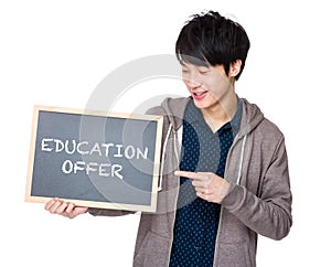 Young man finger point to chalkboard showing education offer