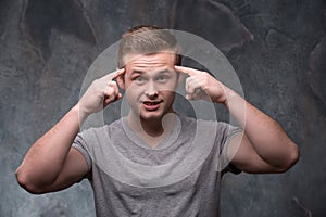 Young man with fingers on his temples