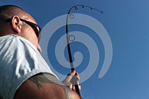 Young man fishing, Fisherman holding rod in action