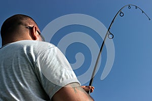 Young man fishing, Fisherman holding rod in action