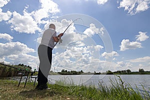 Young man fishing, Fisherman holding rod in action, Angler holding rod in action